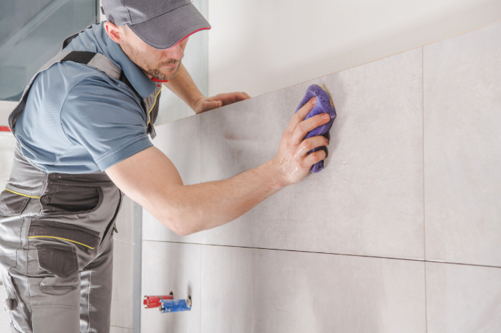 A man doing renovations in bathroom