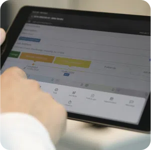 Reporting with Leap CRM shown on a tablet