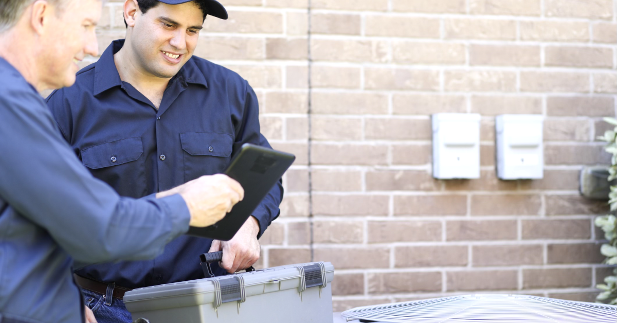 Contractors using HVAC software with QuickBooks on a job